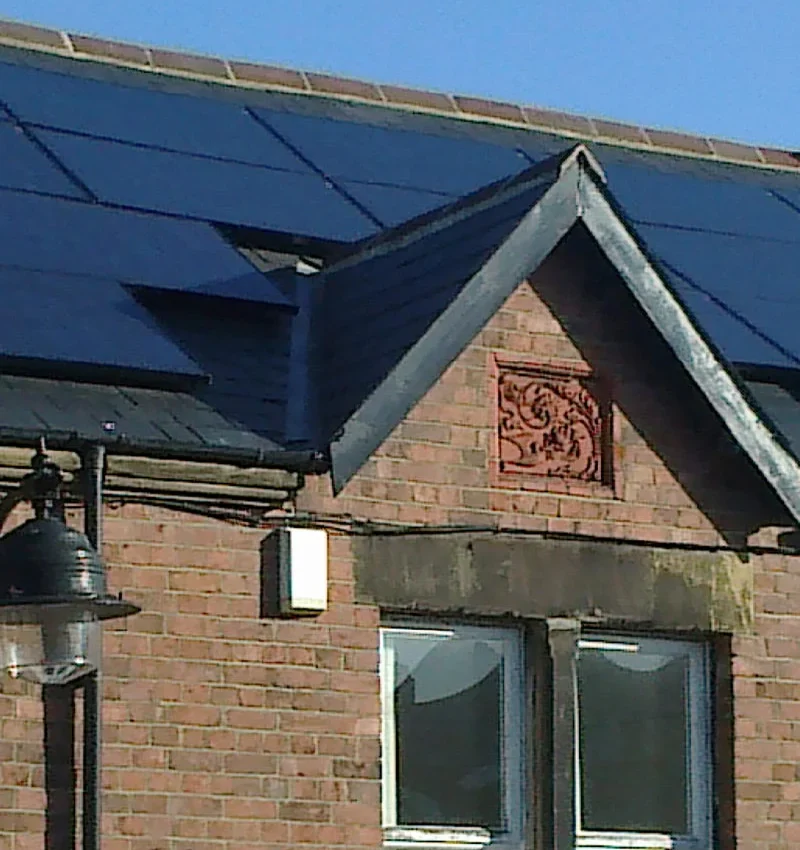 solar panels densely covering a tile roof