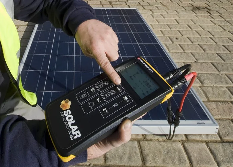 Man holding a device to test the energy output of a solar panel